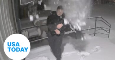 Falling snow pile catches Wisconsin police officer by surprise | USA TODAY